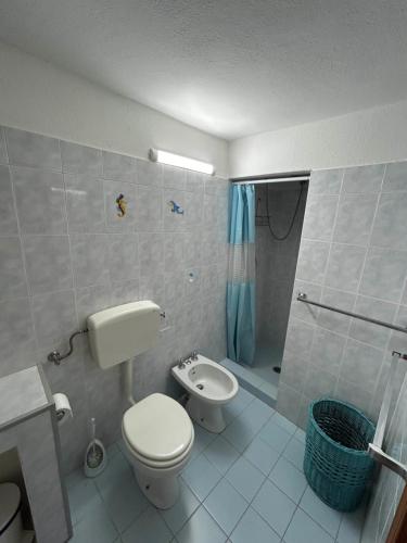a bathroom with a toilet and a shower at Melania Home II in Filicudi