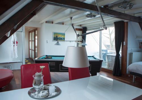 a living room with a table and a pool table at Geinig Amsterdam in Abcoude