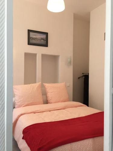 a bedroom with a bed with a red blanket at Appartement Euromed - Les Docks in Marseille