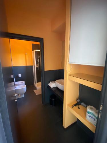 a bathroom with a toilet and a sink and a mirror at Residence Le Volte Apartments in Parma
