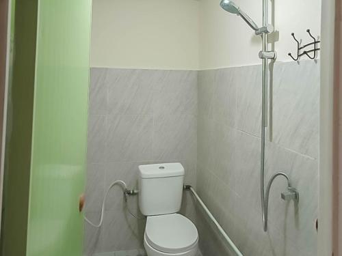 a bathroom with a toilet and a shower at Verisha Inn Singkawang RedPartner in Singkawang
