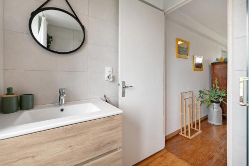 a bathroom with a sink and a mirror at La Bourgerie in Saint-Aubin-des-Bois