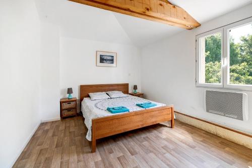 a bedroom with a bed and a window at Domaine De Bellerose in Cadeillan