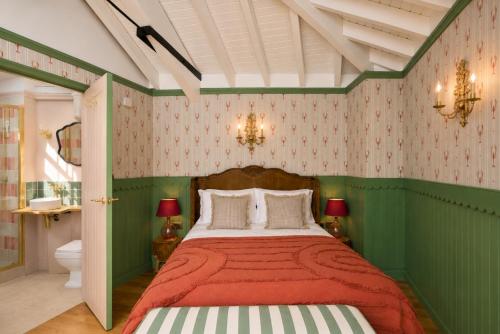 a green bedroom with a bed with a red blanket at The Boathouse - Salcombe - Spring Time Tiny Home in Salcombe