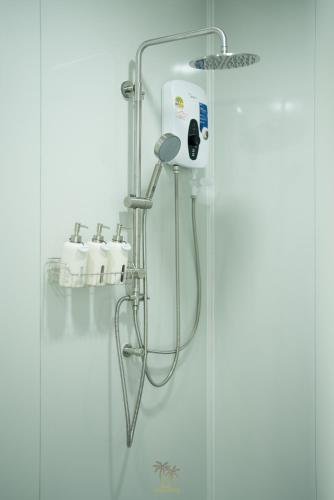 a shower in a bathroom with a glass door at Kood Friends Koh Kood in Ko Kood