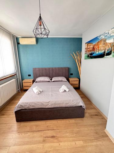 a bedroom with a bed with two towels on it at Семейна къща “Вълчеви” in Kiten