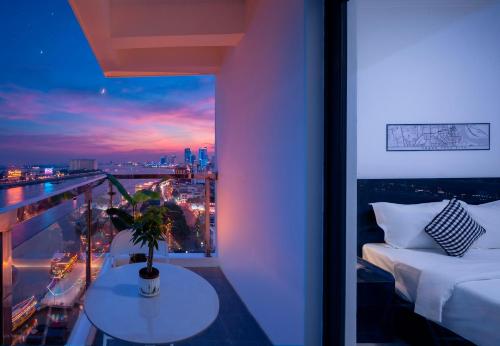 a room with a bed and a view of a city at Mecon Hotel in Phnom Penh