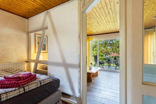 a bedroom with a bed and a sliding glass door at Ferienresidenz Villa Kunterbunt in Warstein