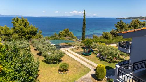 an aerial view of a garden with the ocean in the background at Elegant Maisonettes Elena in Nea Potidaea