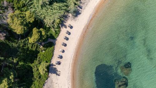 an aerial view of a beach with a group of umbrellas at Elegant Maisonettes Elena in Nea Potidaea