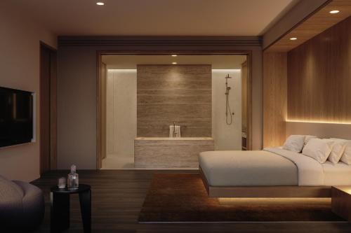 a bedroom with a large bed and a bath tub at Little National Hotel Adelaide in Adelaide