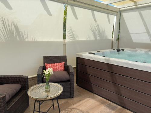 a jacuzzi tub with a couch and a table at Agriturismo Villa Luisa in Apice