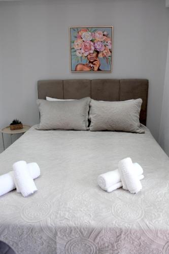 a bed with two white towels on top of it at Diamond Suite in Nea Kallikrateia