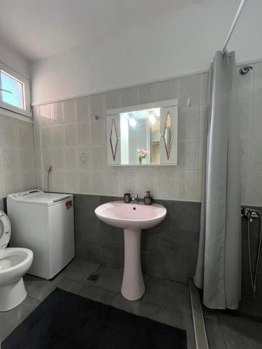 a bathroom with a sink and a toilet at Port House Apartment in Zakynthos