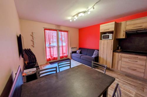 a living room with a table and a couch at Studio 5 personnes au revard in Les Déserts