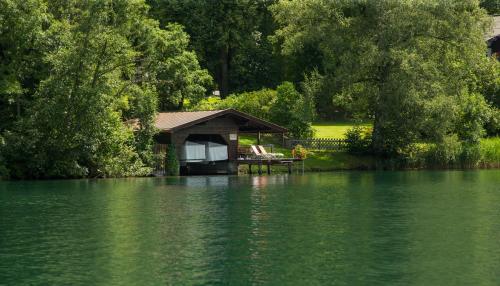 a gazebo on the side of a lake at Der Erlhof Restaurant & Landhotel in Zell am See