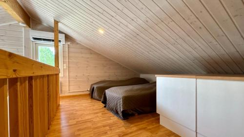 a bedroom with two beds in a attic at Koivulantie 11 A 2 in Tahkovuori