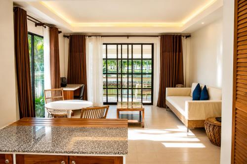 a living room with a couch and a table at Golden Sands Destination Resorts in Daanbantayan