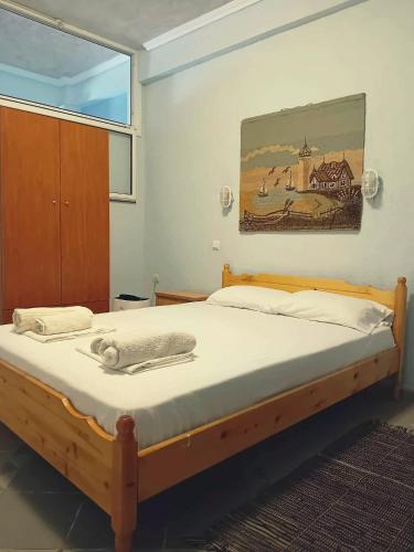 a bed in a bedroom with a picture on the wall at Artemis Studios & Apartments in Nea Kallikrateia