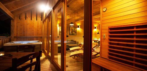 a room with wooden walls and a room with tables at Lavender Hill, Eko Resort & Wellness in Polzela