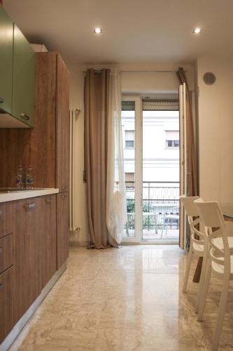 a kitchen with a large window and a table and chairs at Suite in Città residence in Isernia