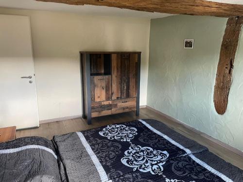 a room with a bed and a wooden door at Ferienhaus an der Felsenkirche in Idar-Oberstein