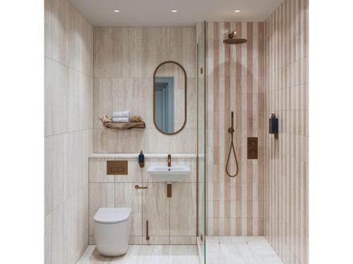 a bathroom with a shower and a toilet and a sink at Elysium St Mawes in Saint Mawes