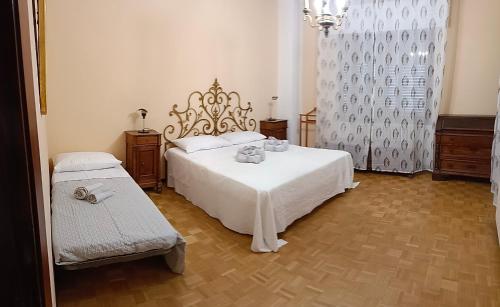 a bedroom with a large white bed and a window at Villa Franca in Cissano