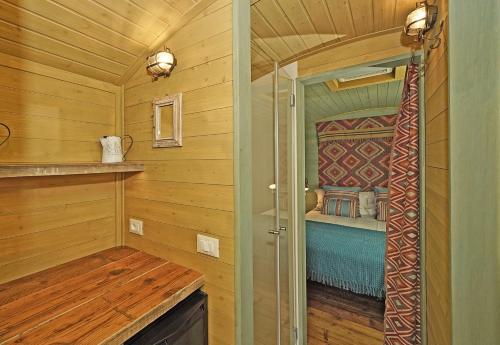 a bedroom with a bed in a wooden room at Pietra Cavalla - Ranch & Resort in Polpenazze del Garda