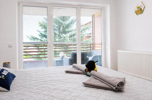 a stuffed animal on pillows on a bed in a bedroom at Honey Apartment in Moravske-Toplice