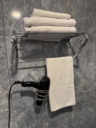 a towel rack with towels on it in a bathroom at Antik Otel in Ankara