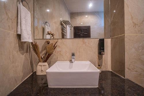 a bathroom with a white sink and a mirror at River View Resort in Haridwār