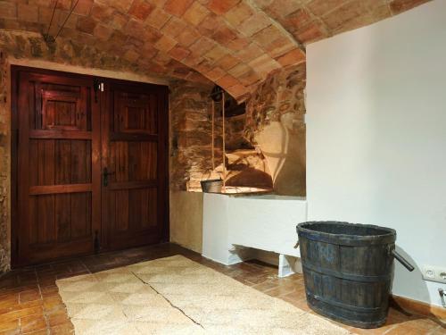 a room with a wooden door and a barrel at Casa historica en Corçà, Baix Empordà in Corçà