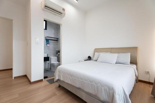 a bedroom with a large white bed and a bathroom at Space Residency 2 bedroom 2 bathroom B59-11 in Johor Bahru