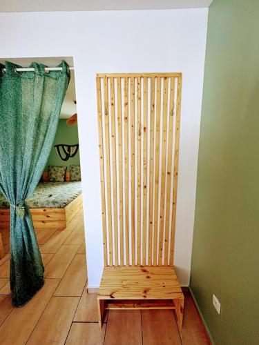 a wooden chair in a room with a curtain at Le Temps d une Pause in Calais