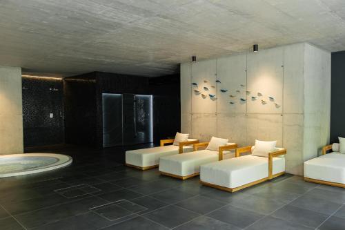 a room with couches and a tub in a building at Hotel Ráztoka in Trojanovice