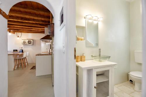 a white bathroom with a sink and a toilet at Villa Joy in Aliki