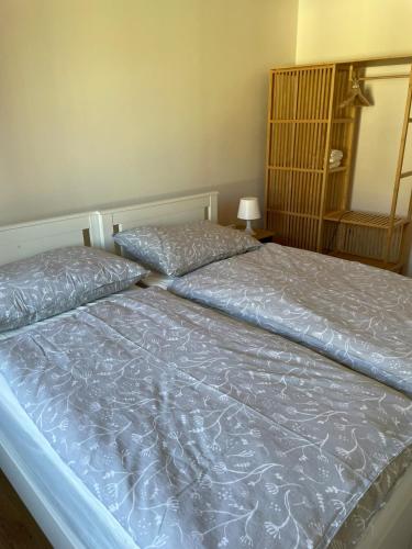 a bedroom with a bed with a blue comforter at Ferienwohung in Maissau in Maissau