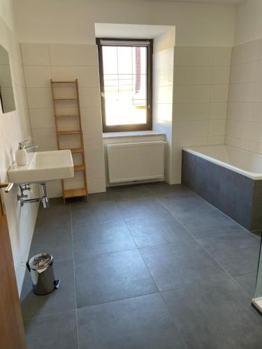a bathroom with a tub and a sink at Ferienwohung in Maissau in Maissau