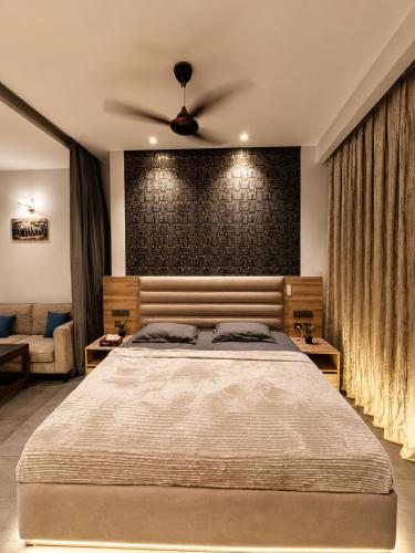 a bedroom with a bed and a brick wall at Skyvera Stay at Supernova Spira in New Delhi