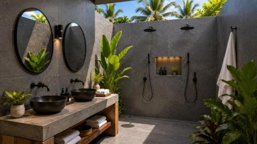 a bathroom with two sinks and two mirrors at The Moso in Moso Island