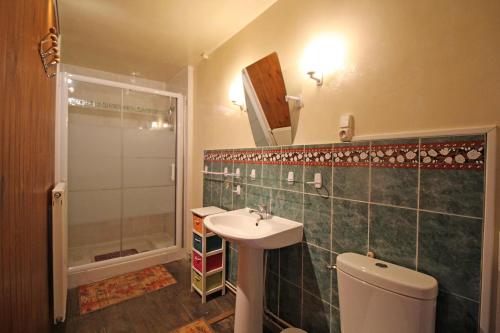 a bathroom with a sink and a shower and a toilet at Boissac in Le Vigen