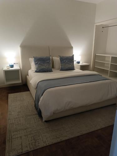 a bedroom with a large bed with two pillows at AP Museu Maputo in Maputo