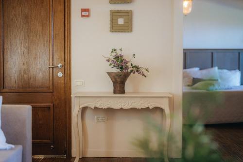 a vase of flowers on a table in a room at The White Chalet Boutique in Moshav Ramot