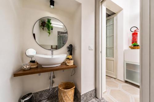 a bathroom with a sink and a mirror at La Madonnella Home - locazione turistica in Adelfia