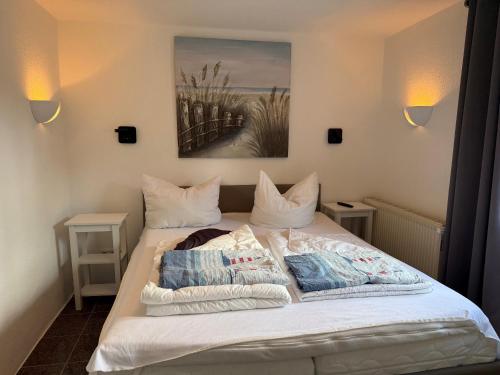 a bedroom with a bed with two pillows on it at Strandoase in Grömitz