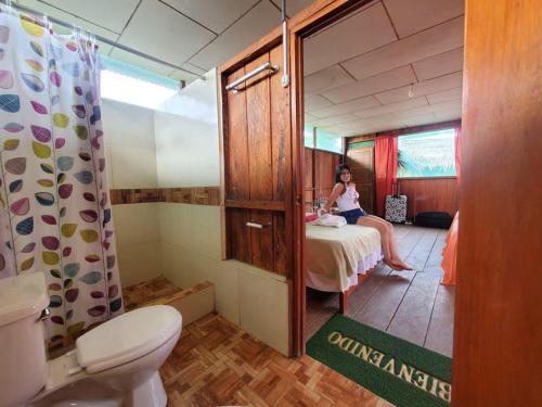 a woman is sitting on a table in a bathroom at Amazon Bromelia Lodge & Expeditions in Iquitos