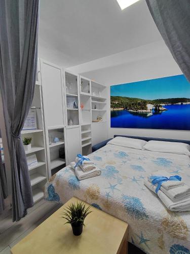 a bedroom with a large bed with a painting on the wall at CASA VACANZE NANA' VIESTE in Vieste