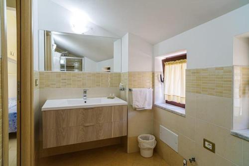 a bathroom with a sink and a mirror at Santa Maria Rooms in Santa Maria di Castellabate