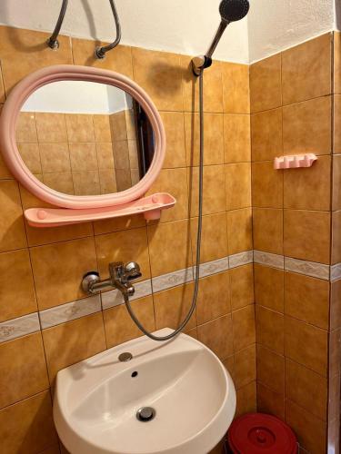a bathroom with a sink and a mirror at H&A Guest House in Golem